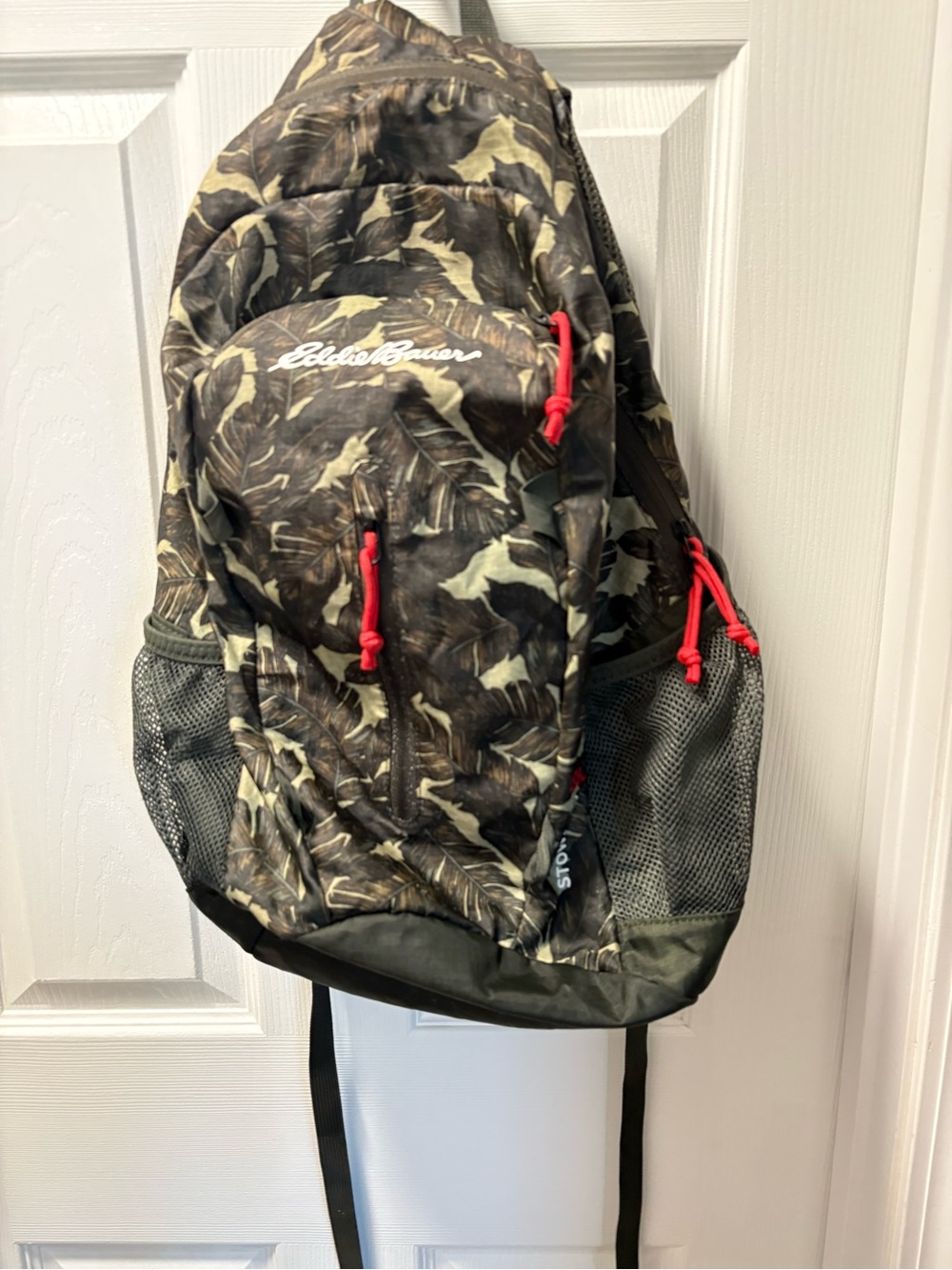 Eddie Bauer Green Camouflage Backpack with Red Accents zipper pulls.